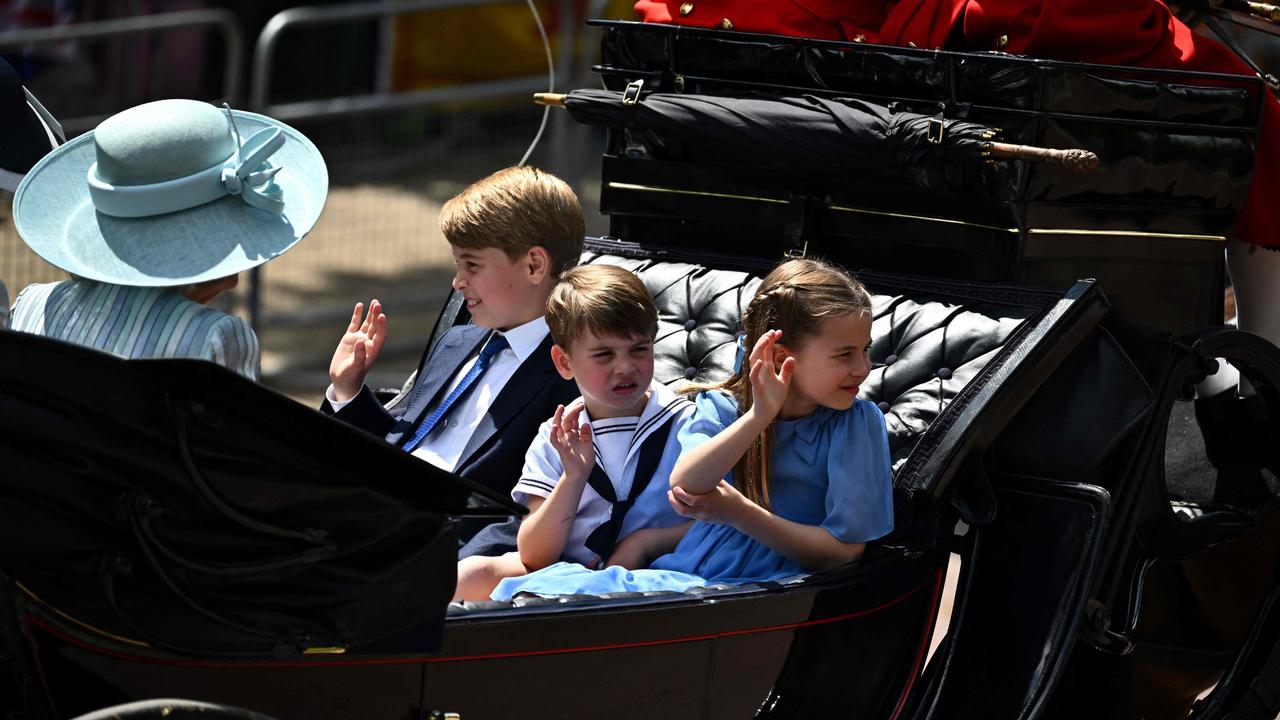 Princes George and Louis and sister Princess Charlotte wave to the massive crowds. Picture: AFP