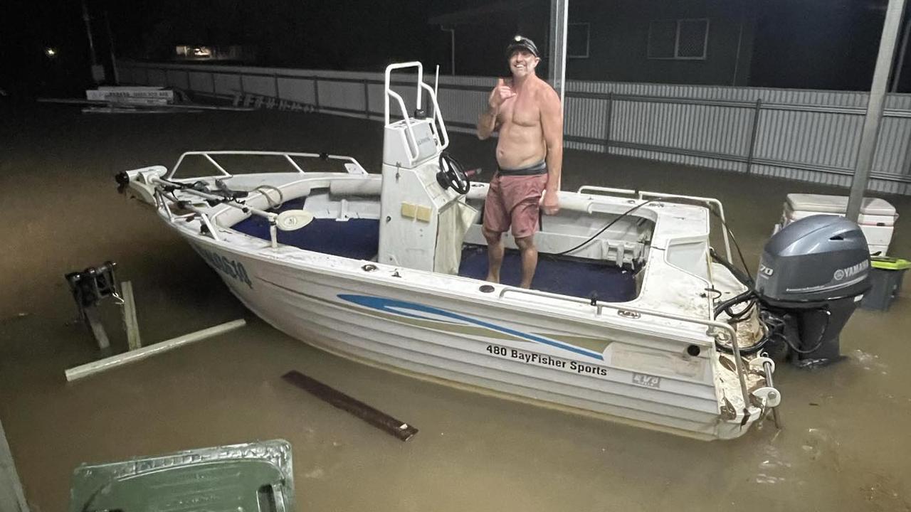 Cardwell resident Brent Churton launched a dinghy from his car port before whisking nearby residents to safety before their home flooded.