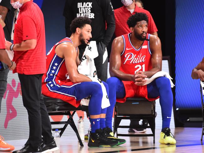 Orlando, FL - AUGUST 5: Ben Simmons #25 of the Philadelphia 76ers and Joel Embiid #21 of the Philadelphia 76ers look on during a game against the Washington Wizards on August 5, 2020 at The Arena at ESPN Wide World of Sports in Orlando, Florida. NOTE TO USER: User expressly acknowledges and agrees that, by downloading and/or using this Photograph, user is consenting to the terms and conditions of the Getty Images License Agreement. Mandatory Copyright Notice: Copyright 2020 NBAE (Photo by Jesse D. Garrabrant/NBAE via Getty Images)