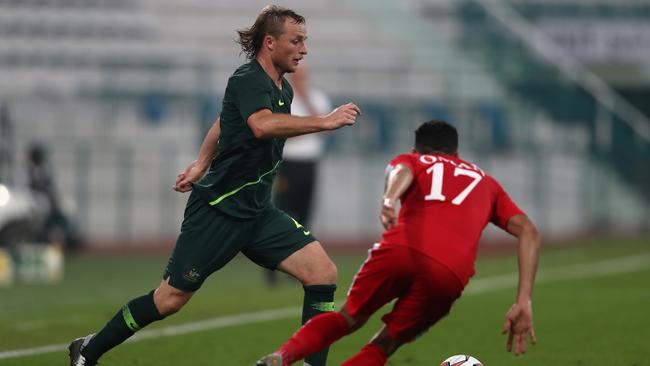 Rhyan Grant rocking the mullet in Australia’s match against Oman on Sunday. Picture: Getty Images 