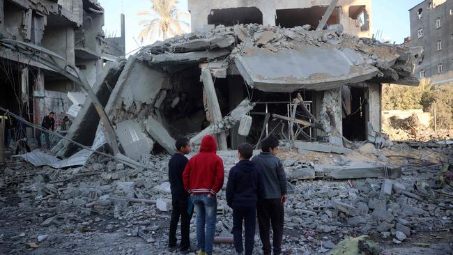 Palestinian children stare at a building destroyed in an Israeli air strike in Nuseirat in the central Gaza Strip on December 1, 2024. Picture: AFP