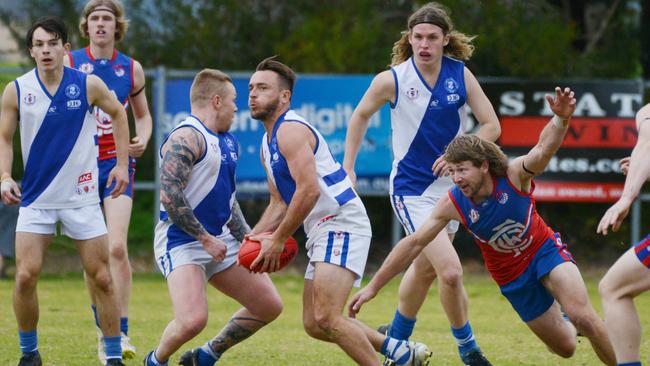 Port Noarlunga’s Aaron Peterson with the ball during the Cockledivers’ clash with Cove on Saturday. Picture: AAP/Brenton Edwards)