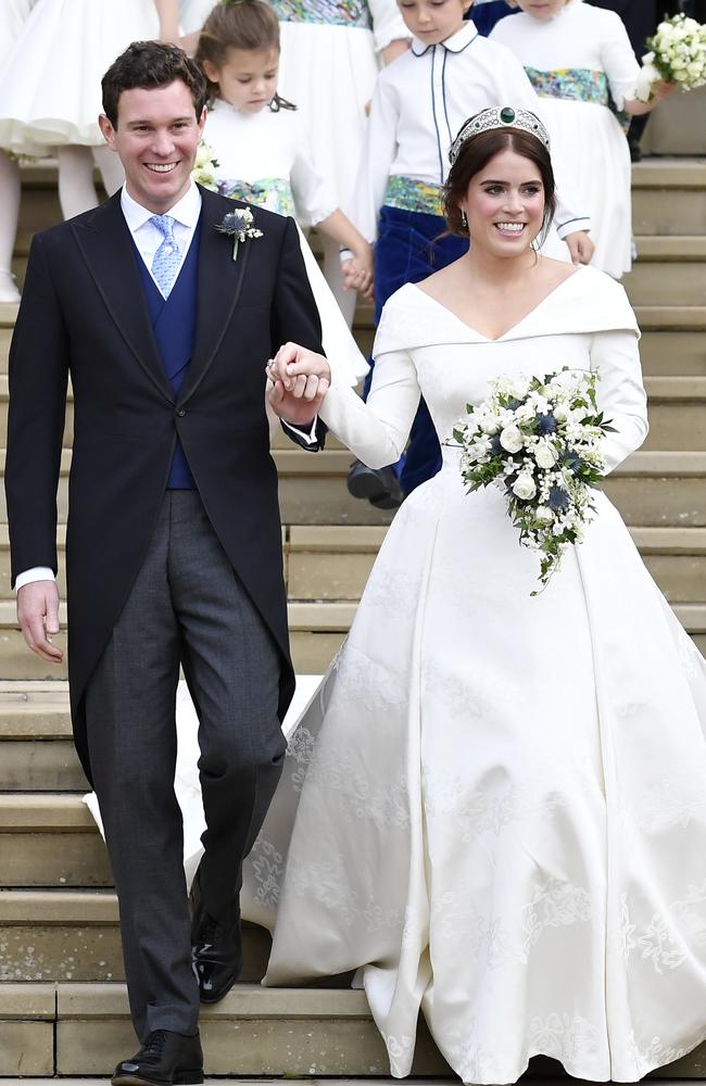 Where’s the honeymoon? Princess Eugenie, right, and Jack Brooksbank pictured leaving St George's Chapel after their wedding at Windsor Castle. Picture: AP