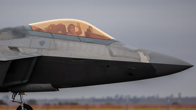 The pilot of a F-22 Raptor waves to observers on February 28 in Avalon.