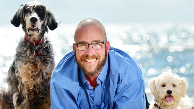 Veteran police dispatcher Rob Barton with his dogs, Jorja and Tilly, at Frankston beach. Picture: Nicki Connolly