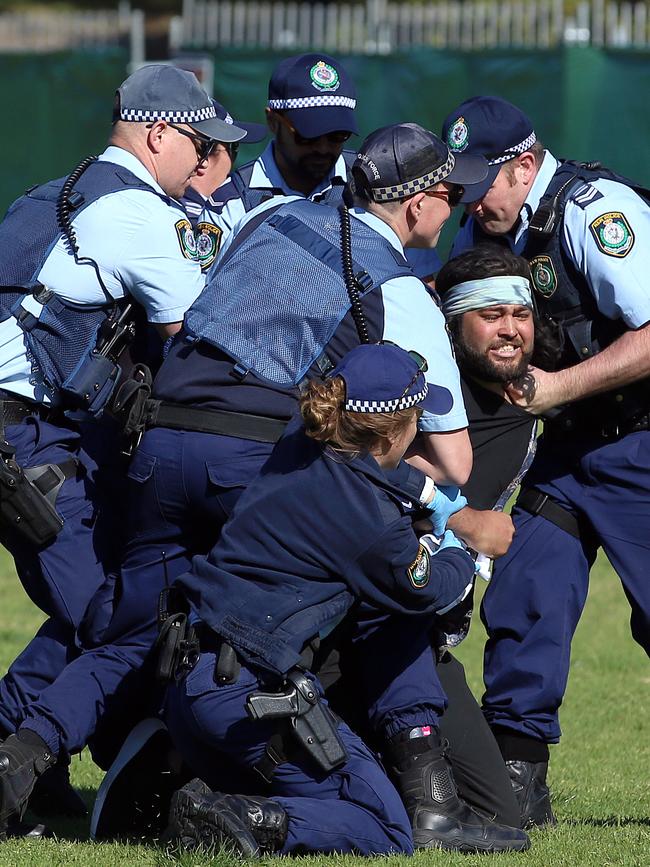 A man is arrested after allegedly pushing a police officer. Picture: Sam Ruttyn