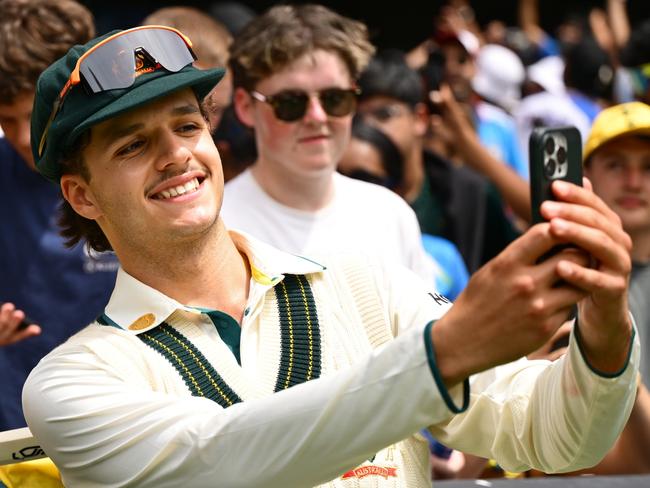 MELBOURNE, AUSTRALIA - DECEMBER 30: Sam Konstas of Australia takes a 'selfie' with fans during day five of the Men's Fourth Test Match in the series between Australia and India at Melbourne Cricket Ground on December 30, 2024 in Melbourne, Australia. (Photo by Quinn Rooney/Getty Images)