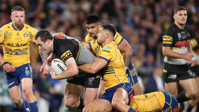 Isaah Yeo of the Panthers is tackled during the match.