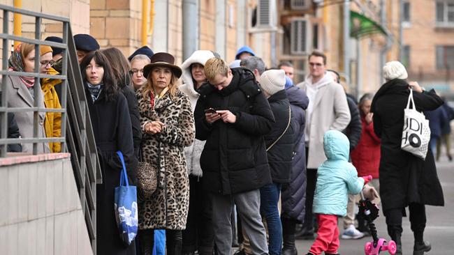 Voters lined up outside a polling station in Moscow at noon yesterday, part of a protest against Vladimir Putin. Picture: Natalia Kolesnikova/AFP