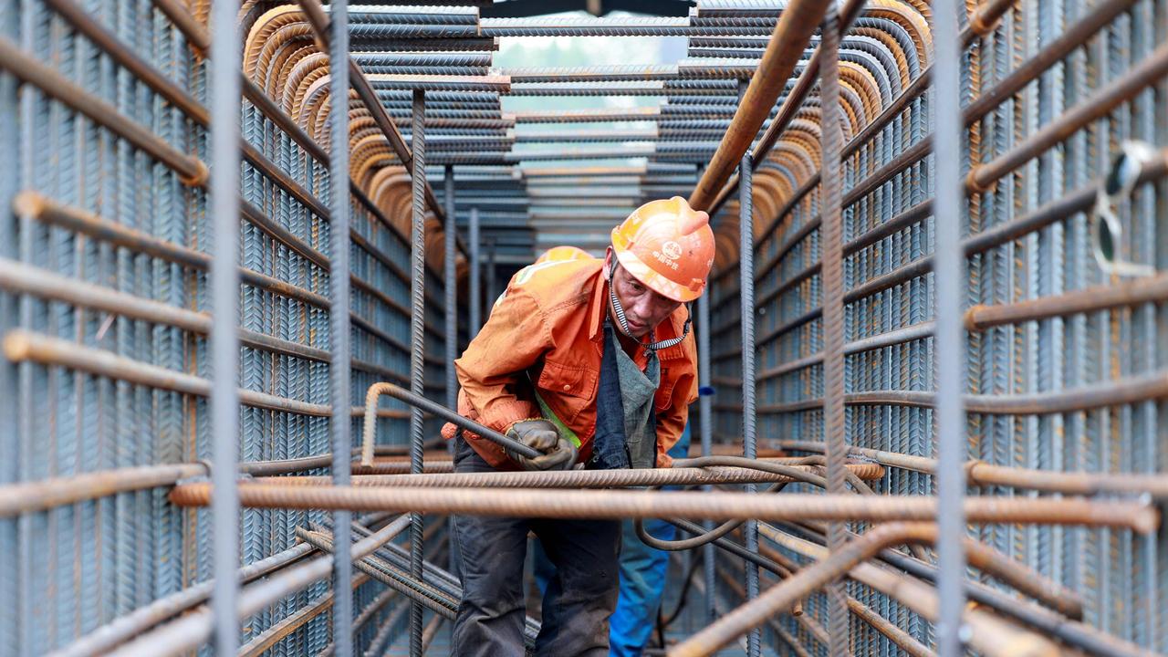 A worker prepares steel bars on the construction site of the Zhangjinggao Yangtze River Bridge on Mazhou Island in Jingjiang, in China. Picture: Stringer/AFP