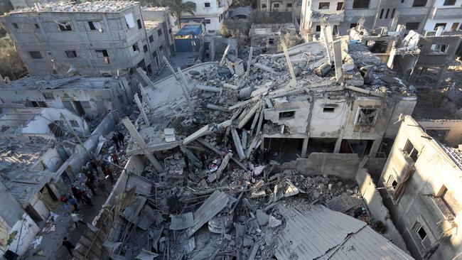 TOPSHOT - Palestinians inspect the damage following Israeli strikes on the Zawayda area of the central Gaza Strip on December 30, 2023, amid ongoing battles between Israel and the Hamas movement. (Photo by AFP)