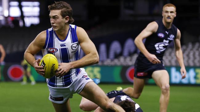 AFL Round 19. Carlton v North Melbourne at Marvel Stadium, Melbourne. 24/07/2021. Will Phillips of the Kangaroos slips the tackle of Sam Walsh of the Blues during the 2nd qtr. . Pic: Michael Klein