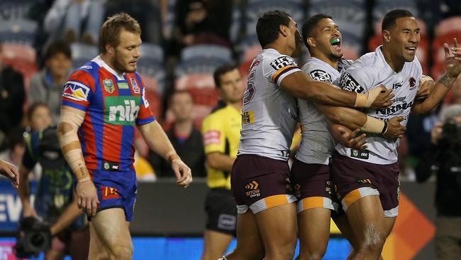 NEWCASTLE, AUSTRALIA — JULY 15: Tautau Moga of the Broncos celebrates his try with team mates during the round 19 NRL match between the Newcastle Knights and the Brisbane Broncos at McDonald Jones Stadium on July 15, 2017 in Newcastle, Australia. (Photo by Ashley Feder/Getty Images)