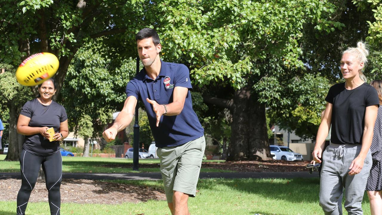 The Serbian superstar even had a crack a handballing a footy with Crows AFLW champion Erin Phillips. Picture: NCA NewsWire/Dean Martin