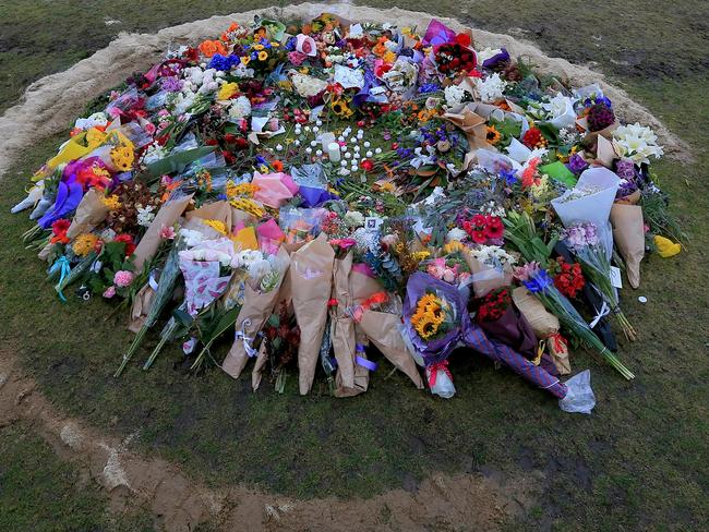 A ring of flowers laid before the Reclaim Princes Park vigil for murdered comedian Eurydice Dixon. Picture: Mark Stewart