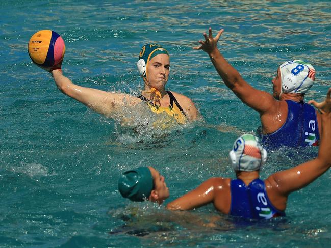 Ash Southern of Australia passes over Roberta Bianconi of Italy during a women’s water polo preliminary match. Italy won the match 8-7