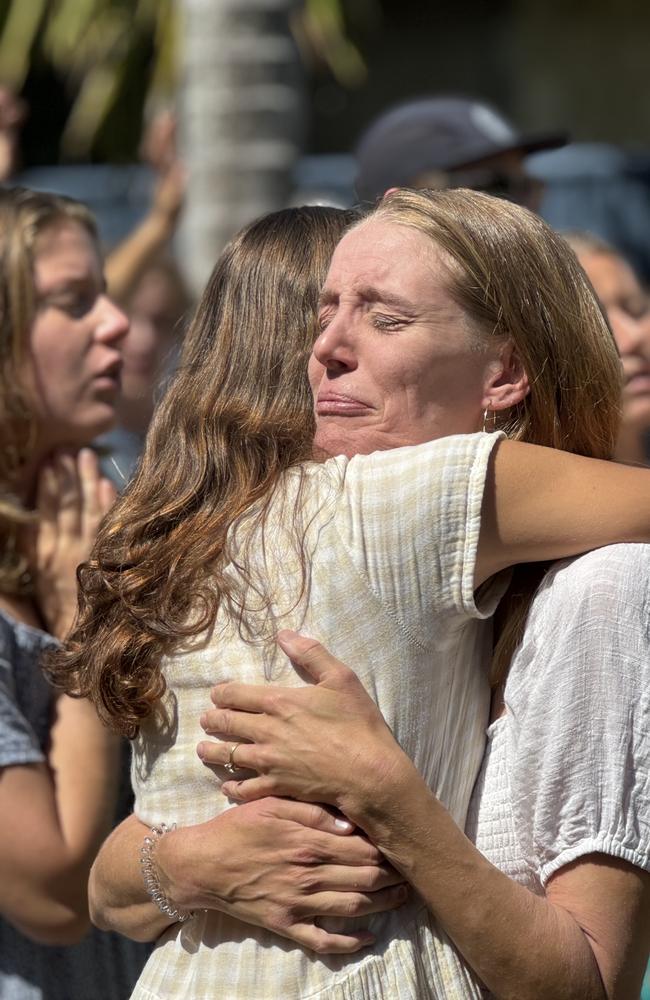 Friends of singer, songwriter and missionary Alex Yurkiv, 19, hug at a service to celebrate his life and legacy.