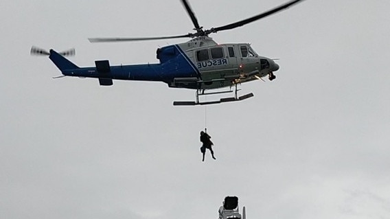 One of the survivors being winched onto the rescue helicopter from the MT Godam in the Torres Strait. Picture: Ritesh Dhamaria