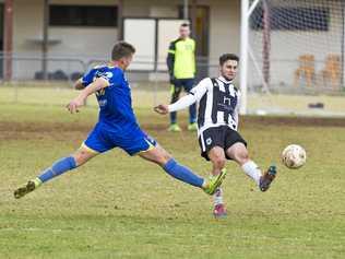 CLOSE MATCH: USQ's Jacob Stoner (left) attempts to block a kick from Willowburn's Nik Lawson during their Toowoomba Football League Premier Men's semi-final at Commonwealth Oval. USQ won the match 2-1. Picture: Kevin Farmer