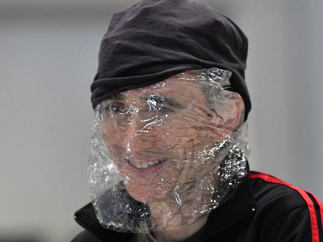 A man is seen with plastic wrapped around his face to protect himself from the Coronavirus (COVID-19) at the Brisbane domestic airport terminal in Brisbane. Picture: AAP