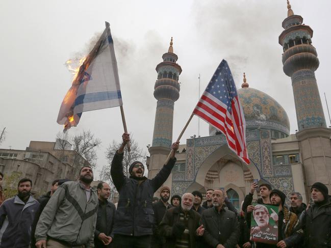 Iranians burn an Israeli and a US flag during an anti-US protest. Picture: AFP