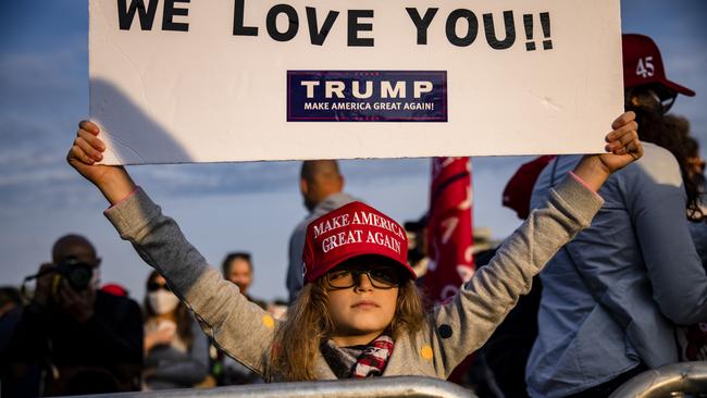 A young supporter makes her feelings clear outside the Walter Reed National Military Medical Centre in Bethesda, Maryland, on Monday. Picture: AFP