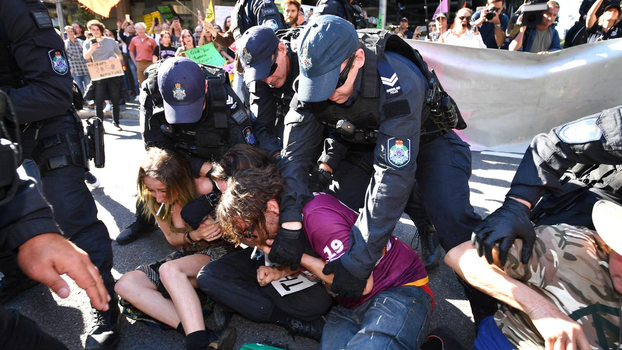 Police arrest Extinction Rebellion protesters during yesterday’s day of action in Brisbane’s CBD. Picture: Darren England/AAP