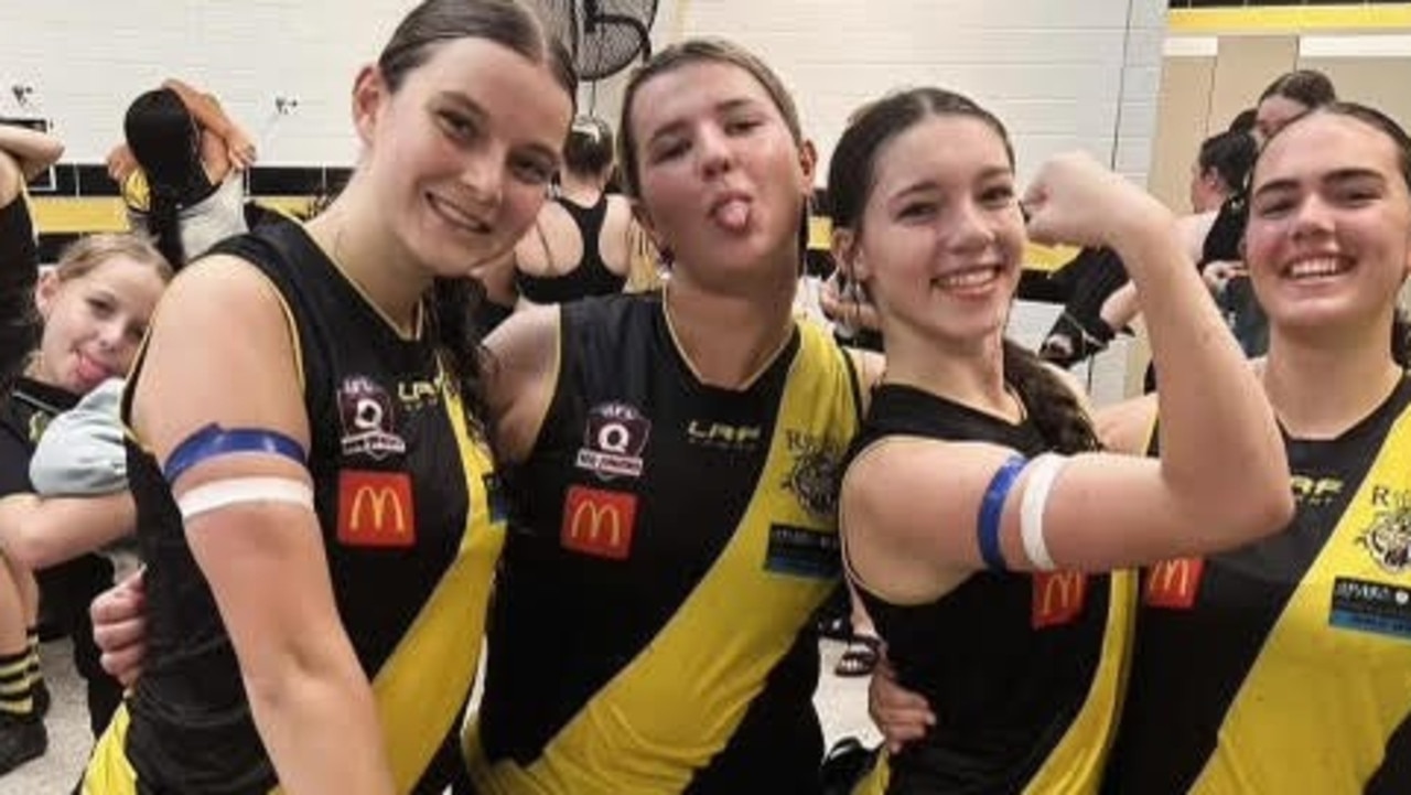 A show of strength. Lucy Riddle, second from the right flexing her muscles, with teammates after the match. Note the blue and white arm bands.