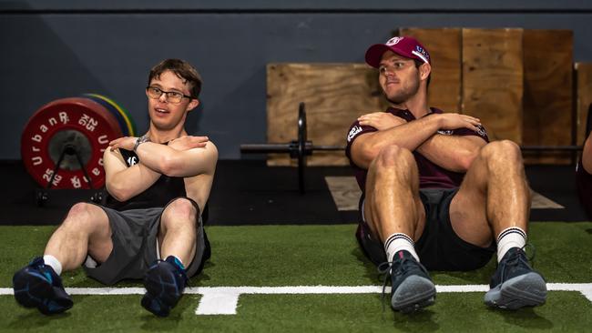 Sea Eagles Corey Waddell and Adrian Millner do some sit-ups together at the Cube Gym. Picture: Monique Harmer.