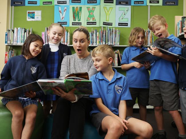 23/8/24: Year 2 students at Woolooware Public School: Olivia, Elke, Teacher, Jill Grant, Max, Darcy (longHair), Louis and Jedd in the school library reading books. John Feder/The Australian