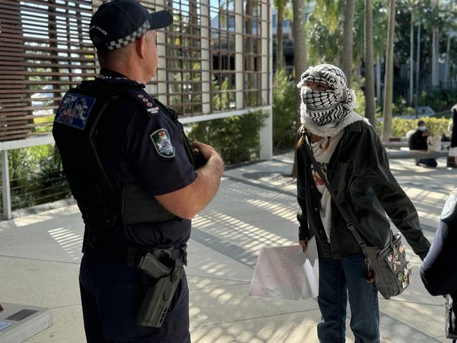 One protester wearing a Palestinian keffiyeh clashed with police outside Council chambers. Picture: Amaani Siddeek