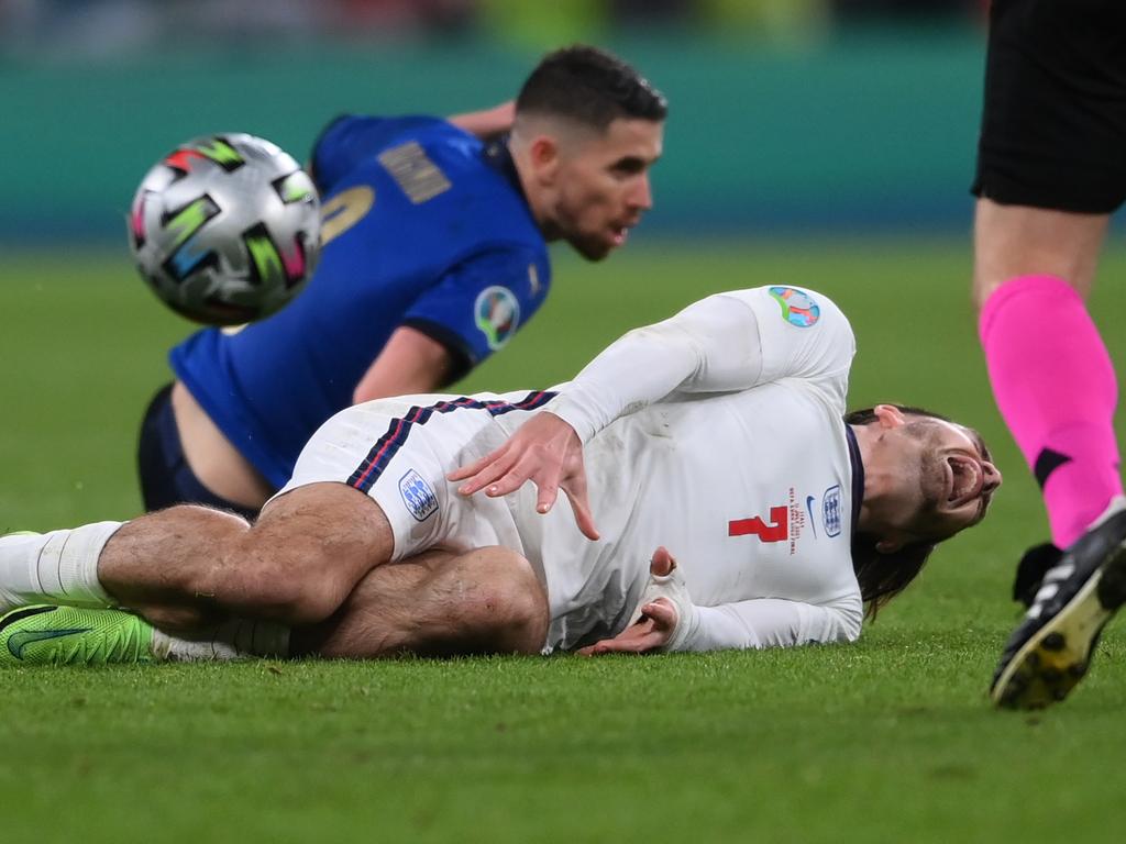 Jack Grealish goes down injured after being fouled by Jorginho.