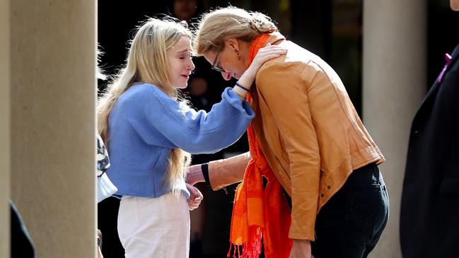 Annaliese with another mourner outside Lily’s funeral. Picture: Kelly Barnes