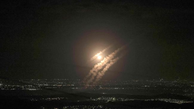 This picture taken from the West Bank city of Hebron shows projectiles above the Israeli city of Ashdod on October 1, 2024. (Photo by HAZEM BADER / AFP)