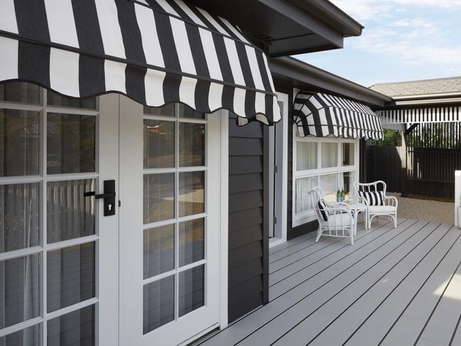 Smart-looking awnings on this 1960s renovation keep sun from reaching the window glass. Picture: Three Birds Renovations