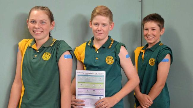 Elizabeth Roth, Hugh Funnell and Trader Ahern receive their immunisations at Burnett State Colege. Picture: Felicity Ripper