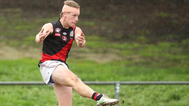 Cameron Sullivan gets a kick for Eltham. Picture: Hamish Blair