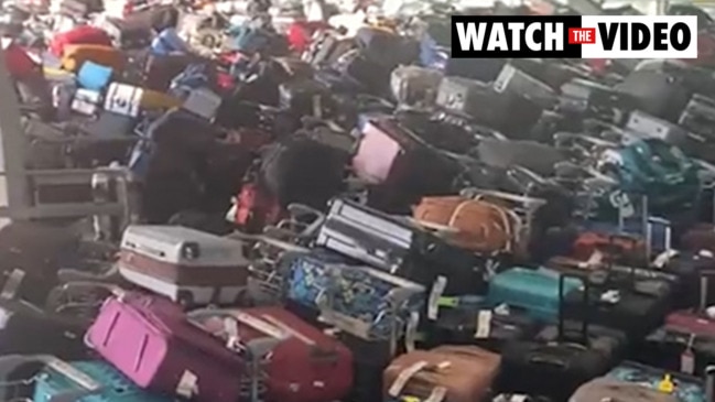 Horror airport scenes as lost bags fill entire lounge