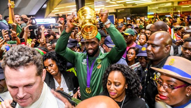 Springboks captain Siya Kolisi holds aloft the Webb Ellis Trophy at Johannesburg airport. Picture: Getty Images