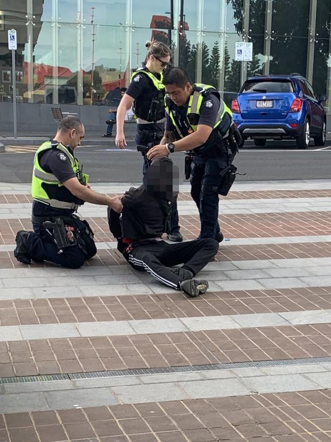 Police restrain a teen after he verbally abused a female police officer.