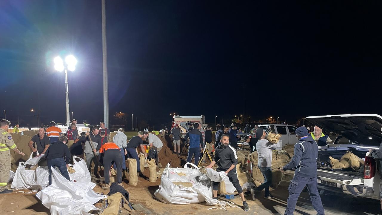 Volunteers and emergency services packed sandbags on Saturday night at the Shepparton Showgrounds. Picture: Kiel Egging