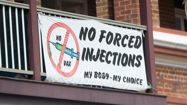 Anti Vaxxers hang a protest sign in the main street of Mullumbimby, in Ballina, NSW. Picture: NCA NewsWire / Scott Powick