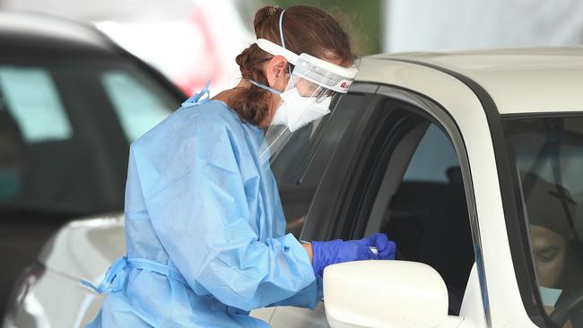 GOLD COAST, AUSTRALIA - JANUARY 05: People are tested for Covid-19 at Southport on January 05, 2022 in Gold Coast, Australia. Queensland is experiencing record-high COVID-19 cases for the state, creating challenges for testing clinics.  (Photo by Chris Hyde/Getty Images)