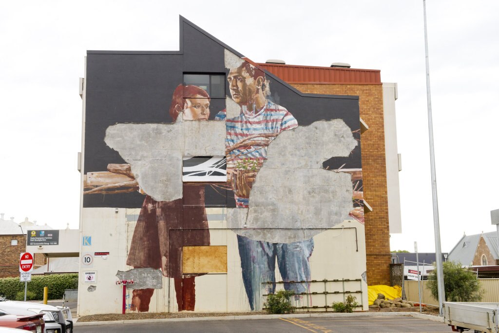 MISSING PARTS: Fintan Magee&#39;s SES mural on Hume St, which has been partially destroyed. Picture: Nev Madsen