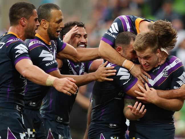 Cameron Munster of the Storm celebrates scoring a try with his teammates during the round four NRL match between the Melbourne Storm and the Canterbury Bulldogs. Picture: Getty