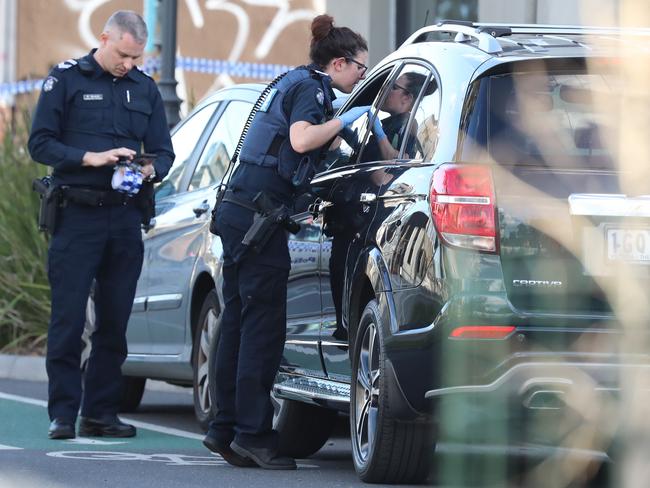 Police check cars for a weapon. Picture: Alex Coppel