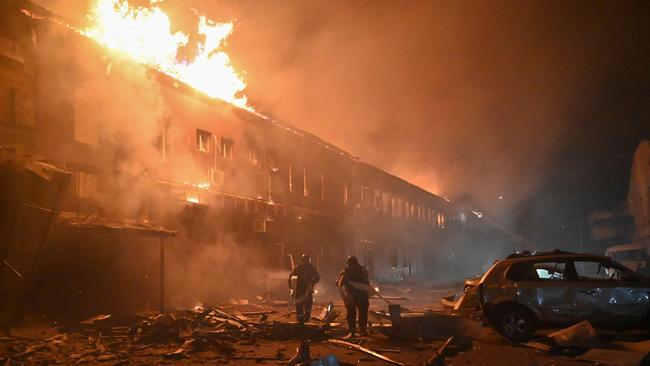 State Emergency Service rescuers work to extinguish a fire in a building after a drone strike in Kharkiv on January 28. Picture: Sergey Bobok / AFP