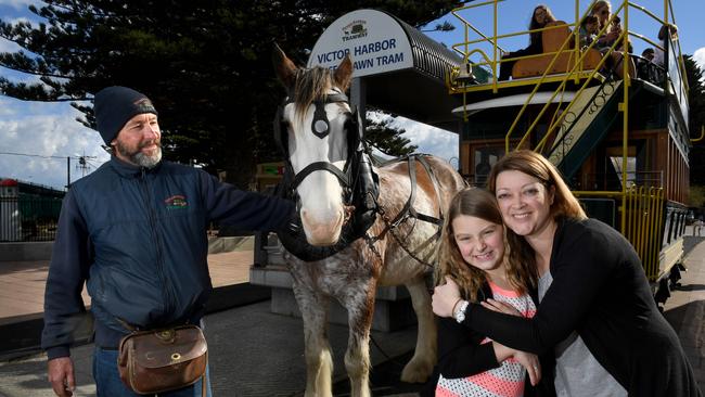 DRAWCARD: Denny Steer and daughter Imogen, board Victor Harbor’s renowned horse-drawn tram, driven by Adrian Cox. <b/>Picture: Tricia Watkinson