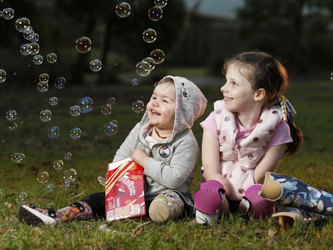 Carrie Giles, 2, and Mia Wilkinson, 7, posing at Kallangur, Brisbane. Mia and Carrie both lost their limbs due to complications with Sepsis. (Image/Josh Woning)