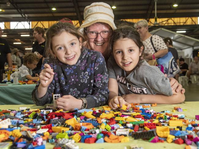 On holiday from Canada, Tilly and Layla Donnelly with their grandmother Liz Donnelly play in the lego area. Toowoomba Royal Show. Saturday, April 1, 2023. Picture: Nev Madsen.